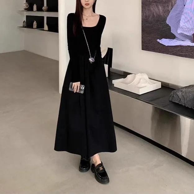 Women's black square collar knitted A-line dress with long sleeves on a hanger.