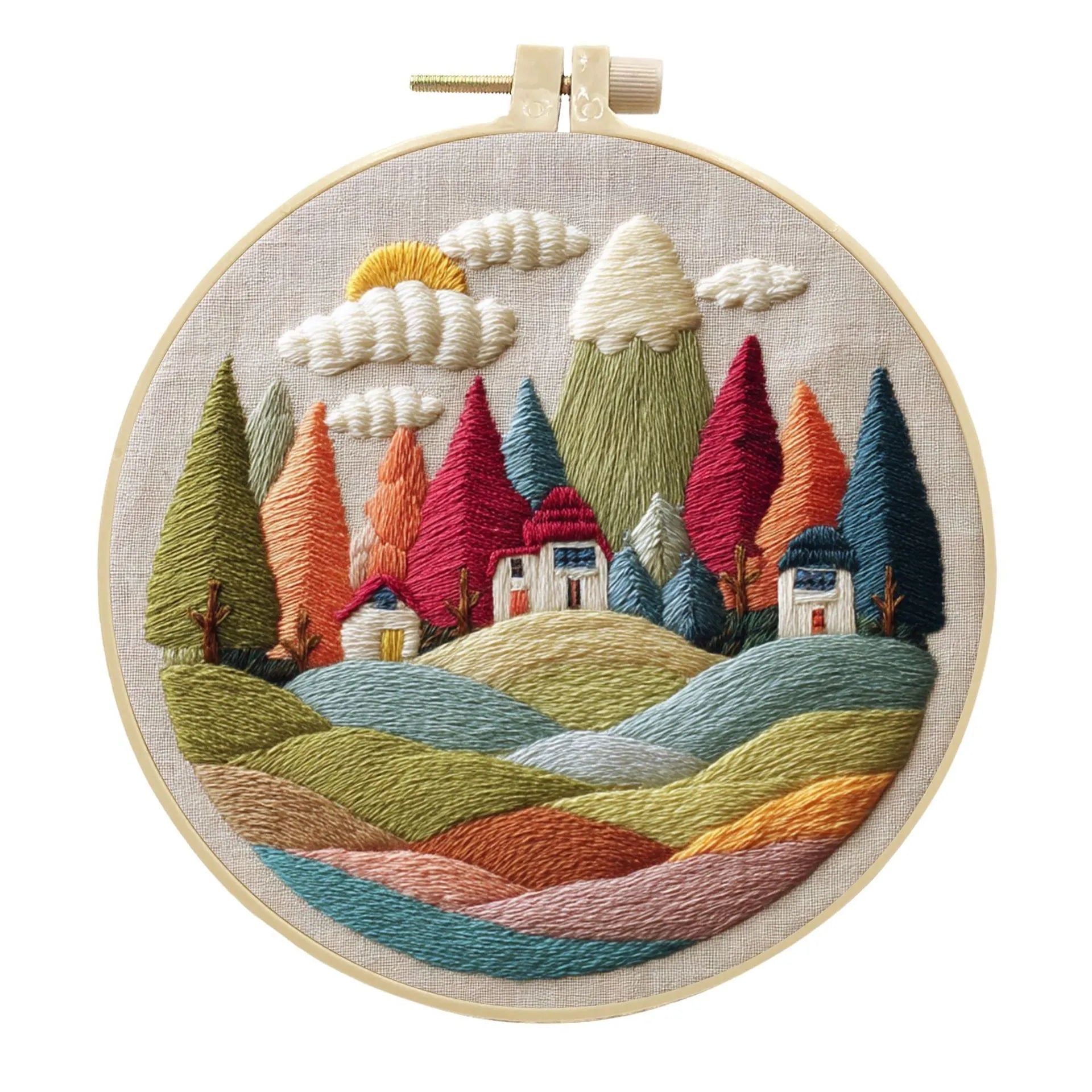 Embroidery DIY kit with bamboo frame, cotton fabric printed with a landscape scene, threads, and needles laid out