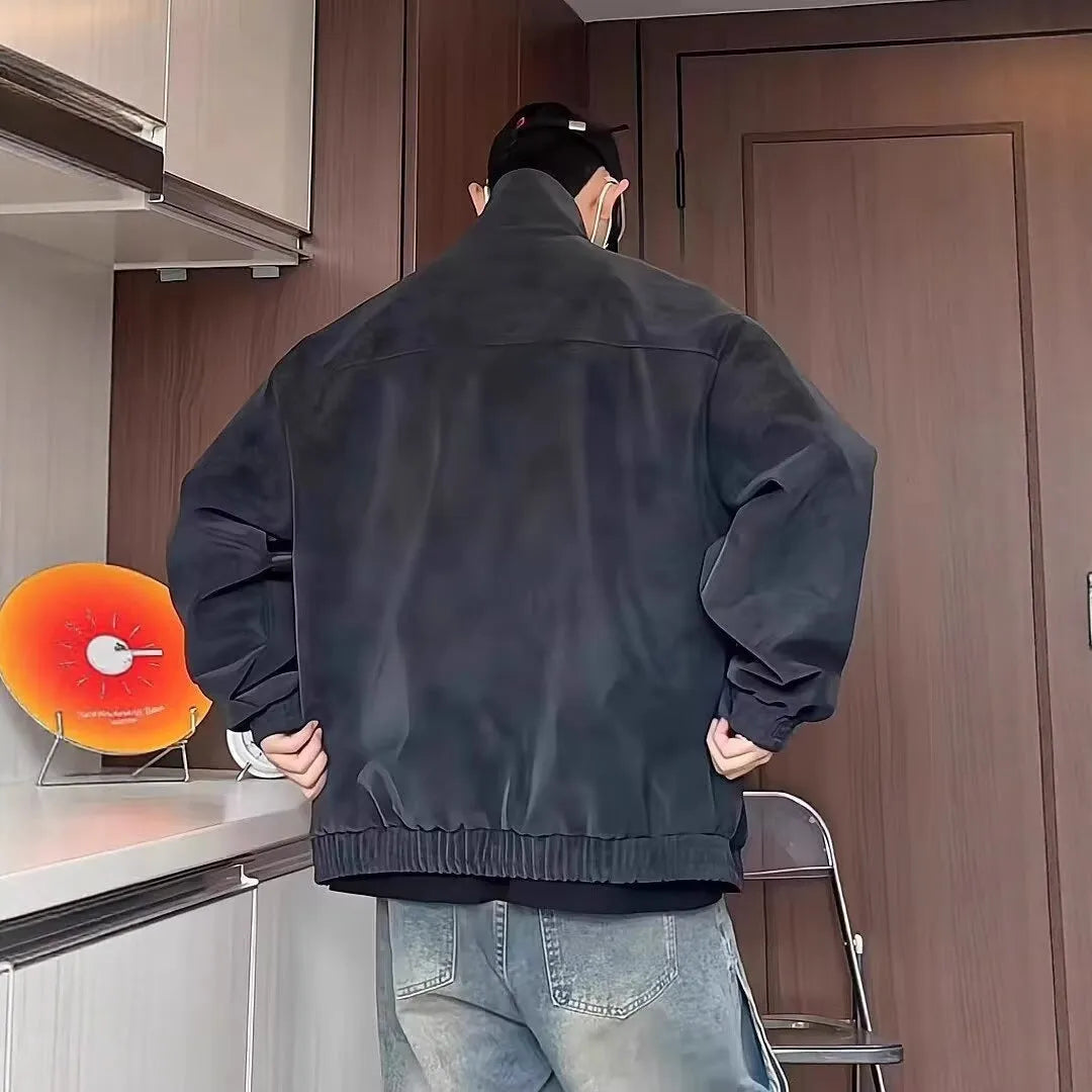 Man wearing a grey vintage tie-dyed PU leather jacket with a stand collar and side pockets.