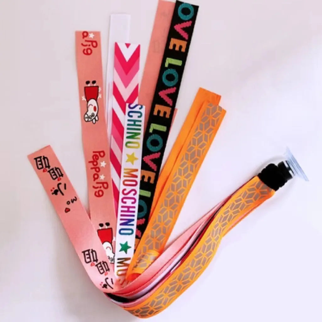 Colourful fabric helmet streamers for children's roller skating and ski helmets, shown in apricot, red, and grey.