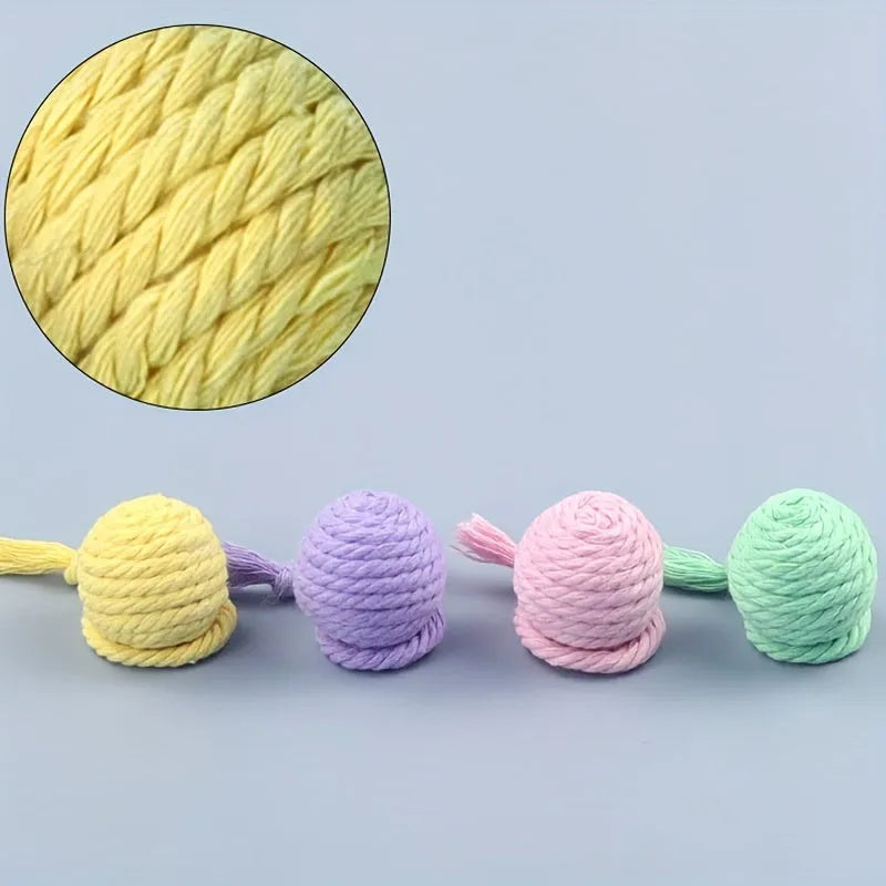 Interactive cat toy ball with rope and internal bell in green, pink, purple and yellow colours