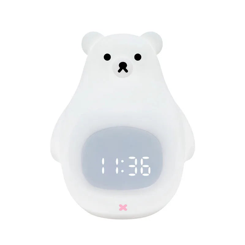 White silicone bear-shaped night light with a remote control on a wooden surface.