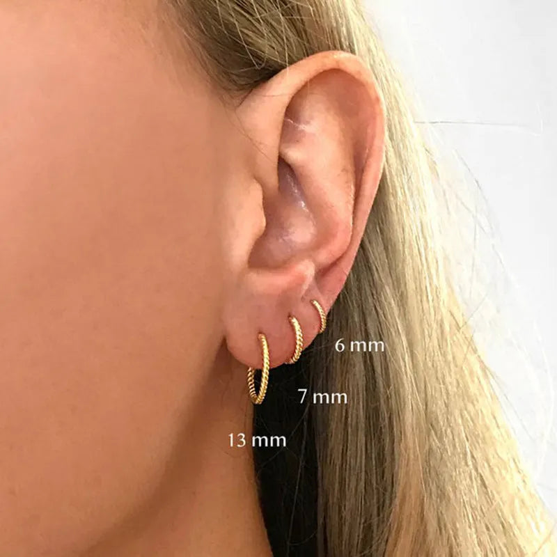 Sterling silver twisted ring earrings in geometric round design with gold or white gold finish