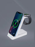 Black 3-in-1 wireless charging dock showing a phone charging vertically, with spots for AirPods and Apple Watch.