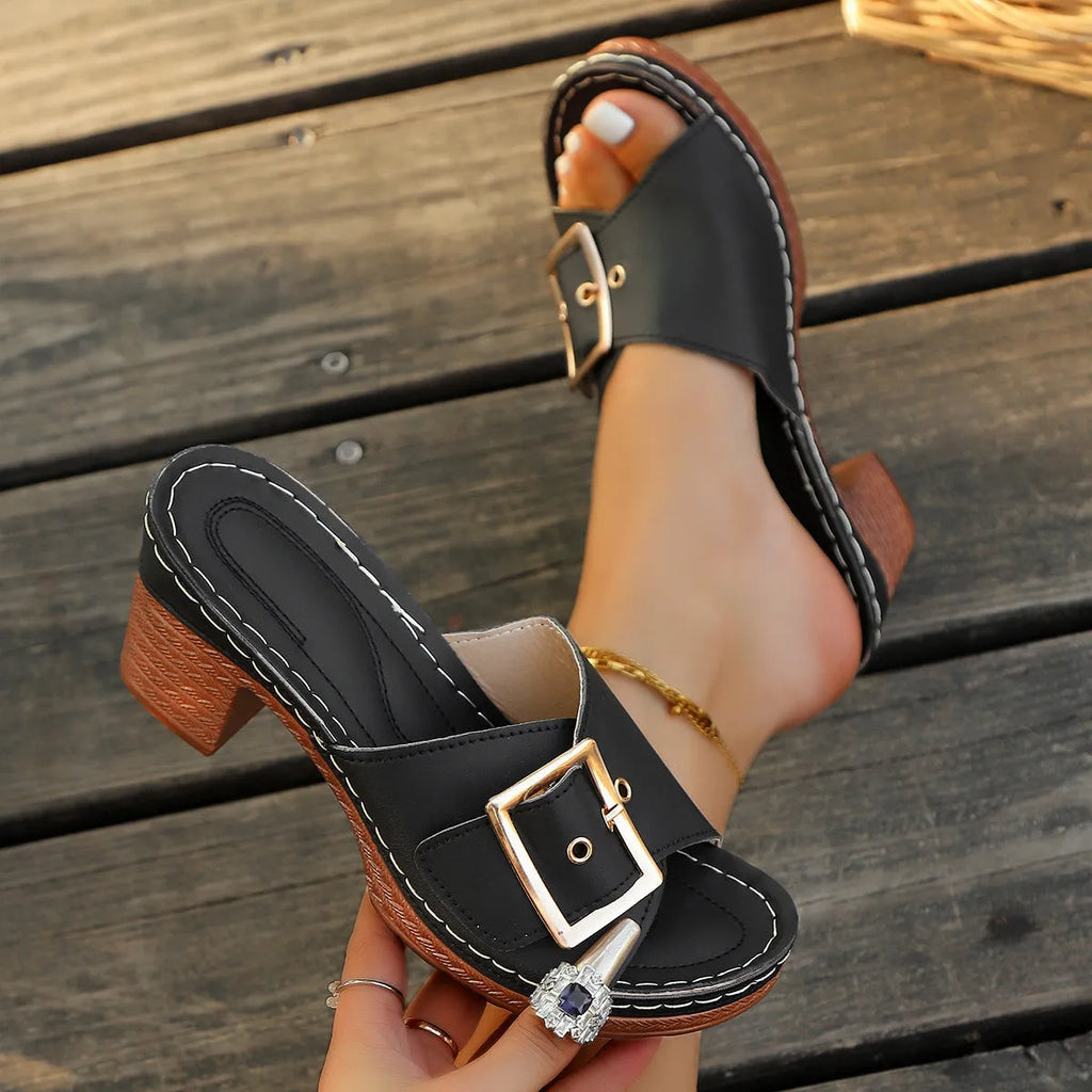 Women's black chunky heel slippers with silver metal buckle and round toe