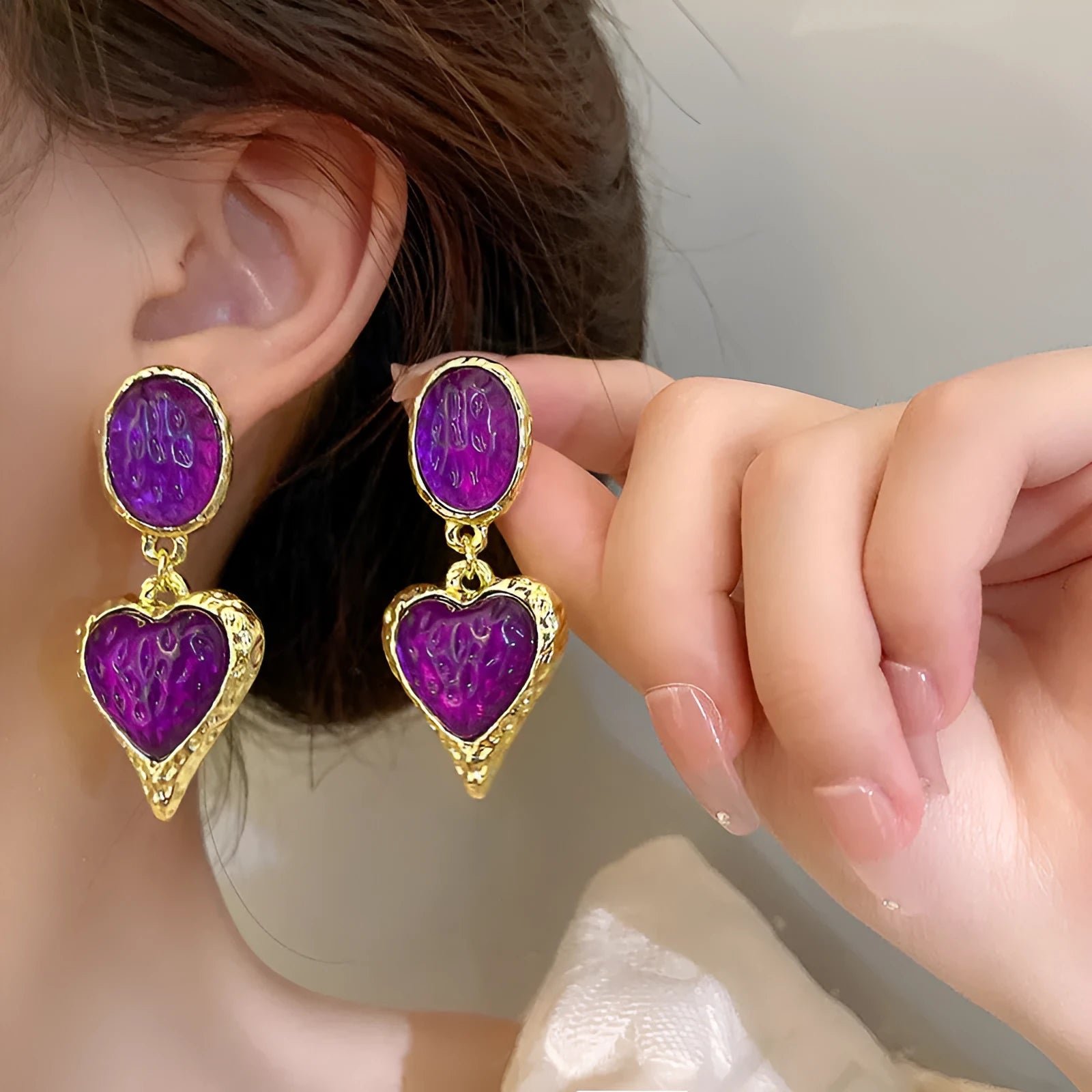 Silver textured oval love heart stud earrings in purple, red, green, and yellow white on a jewellery card.