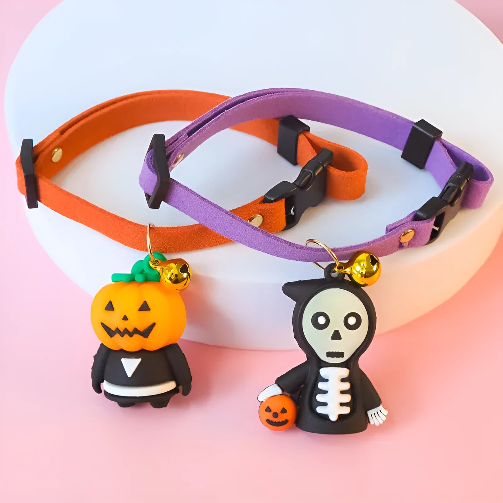 Halloween dog collar with pumpkin man and glow-in-the-dark skull designs in adjustable sizes.