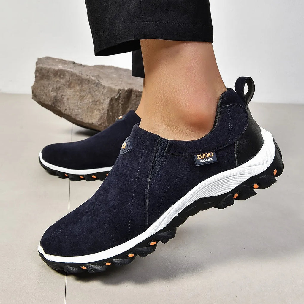 Men's black elastic slip-on shoe covers with round toe and rubber sole, showing PU upper material.