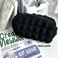 Beige fabric pencil case with a cream puff textured design for holding pens and pencils.