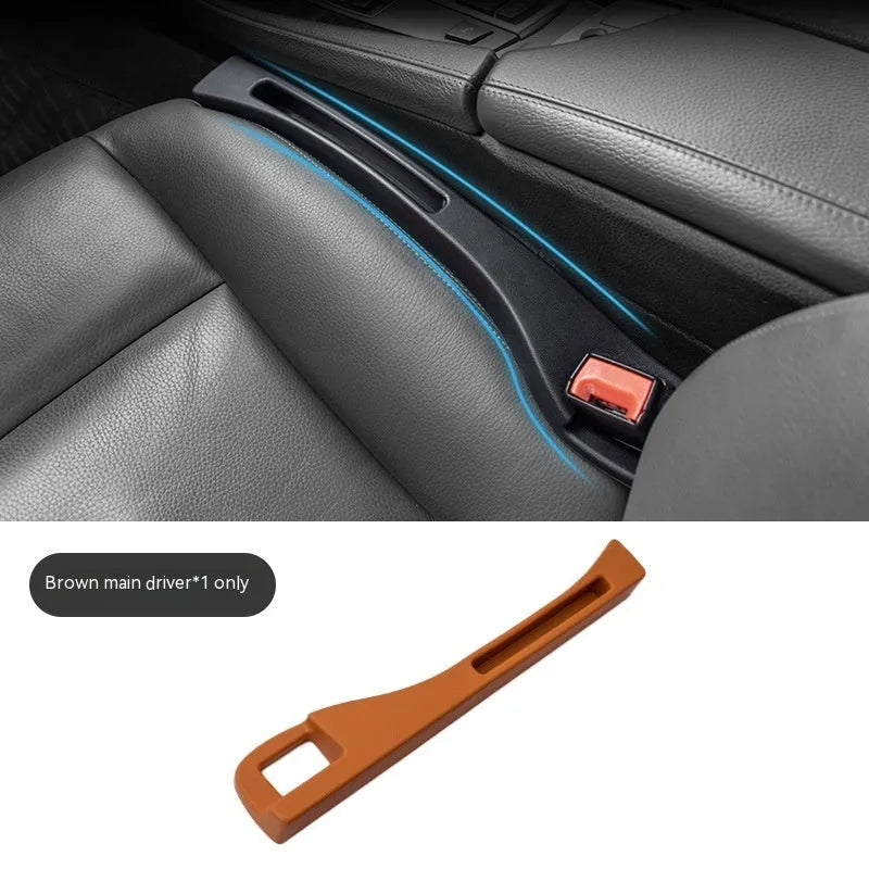 Black plastic car seat gap storage organiser box with handle inserted between car seat and centre console.