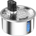 Stainless steel heated pet water fountain with charging cable on a white base.