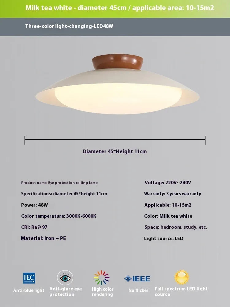 Modern minimalist cream style flying saucer ceiling lamp in mint green on a white ceiling.