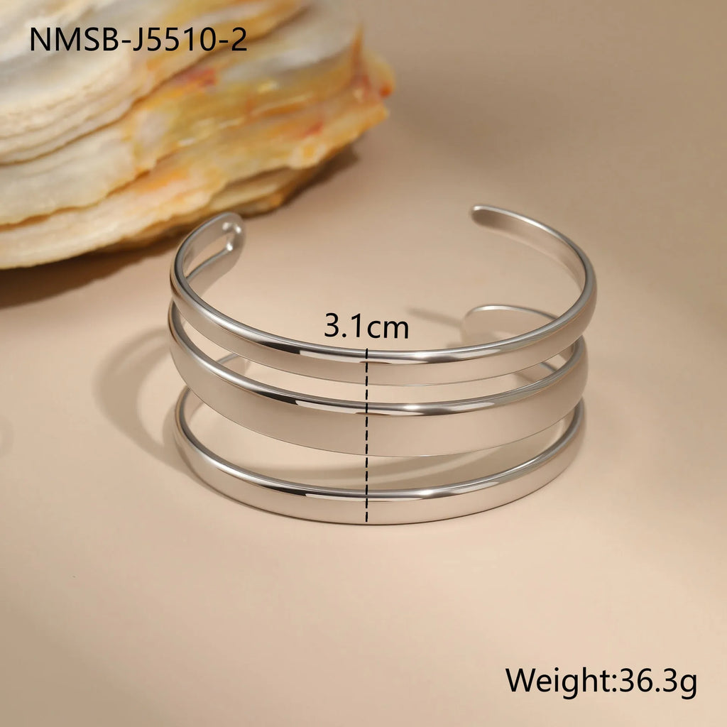 Geometric stainless steel women's bracelet with a simple opening, shown in gold and steel colour options.