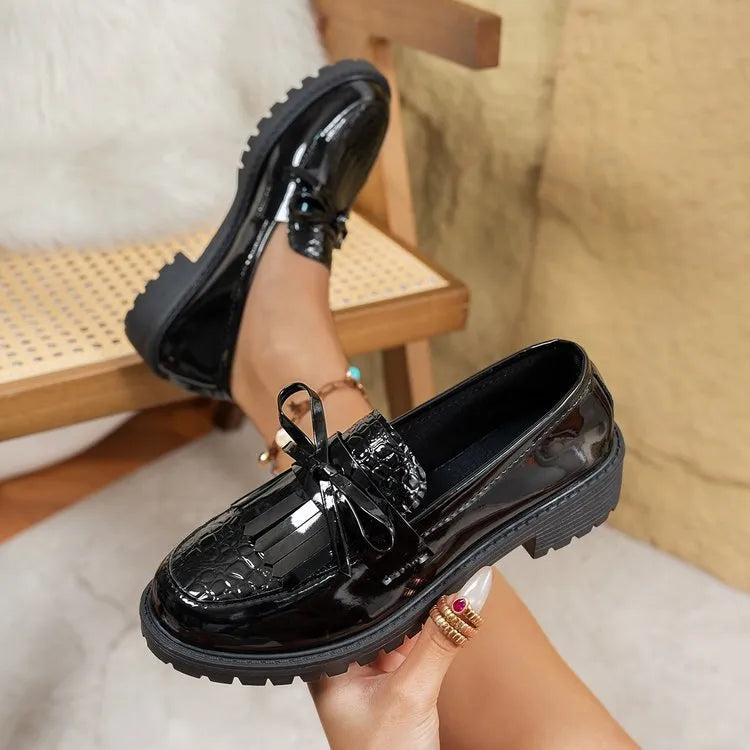 Brown women's flat loafers with a decorative bow and elastic slingback.