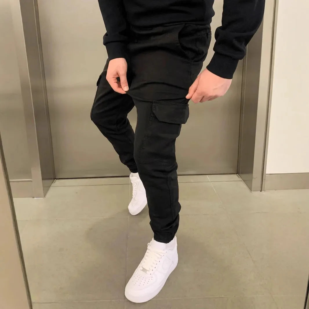 Men's casual straight-leg trousers with patch pockets in polyester fabric, available in seven colours with elastic waistband