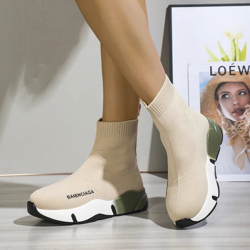 Women's black platform sock boots with cloth upper, rubber sole, round toe, thick heel, and low tube design on a neutral background