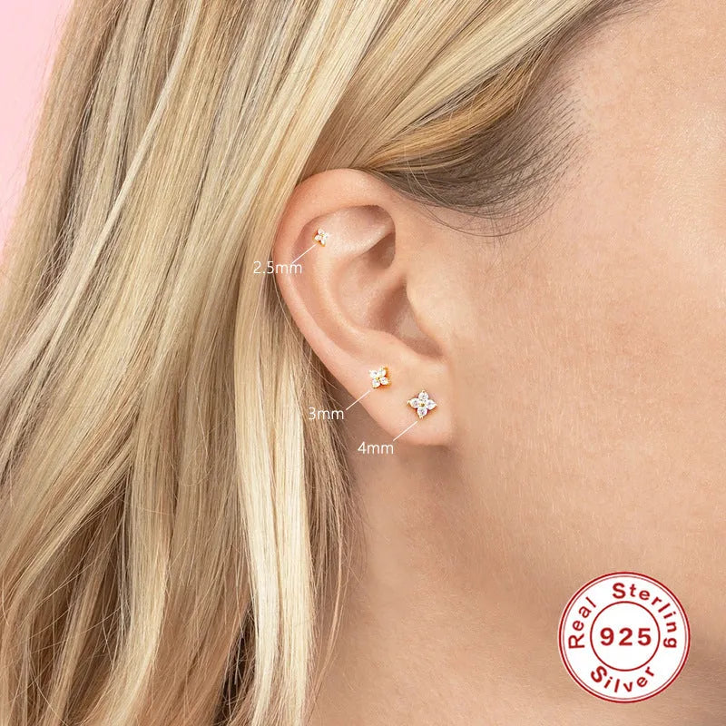 S925 sterling silver stud earrings with small petal crystal flowers in gold and platinum finishes.