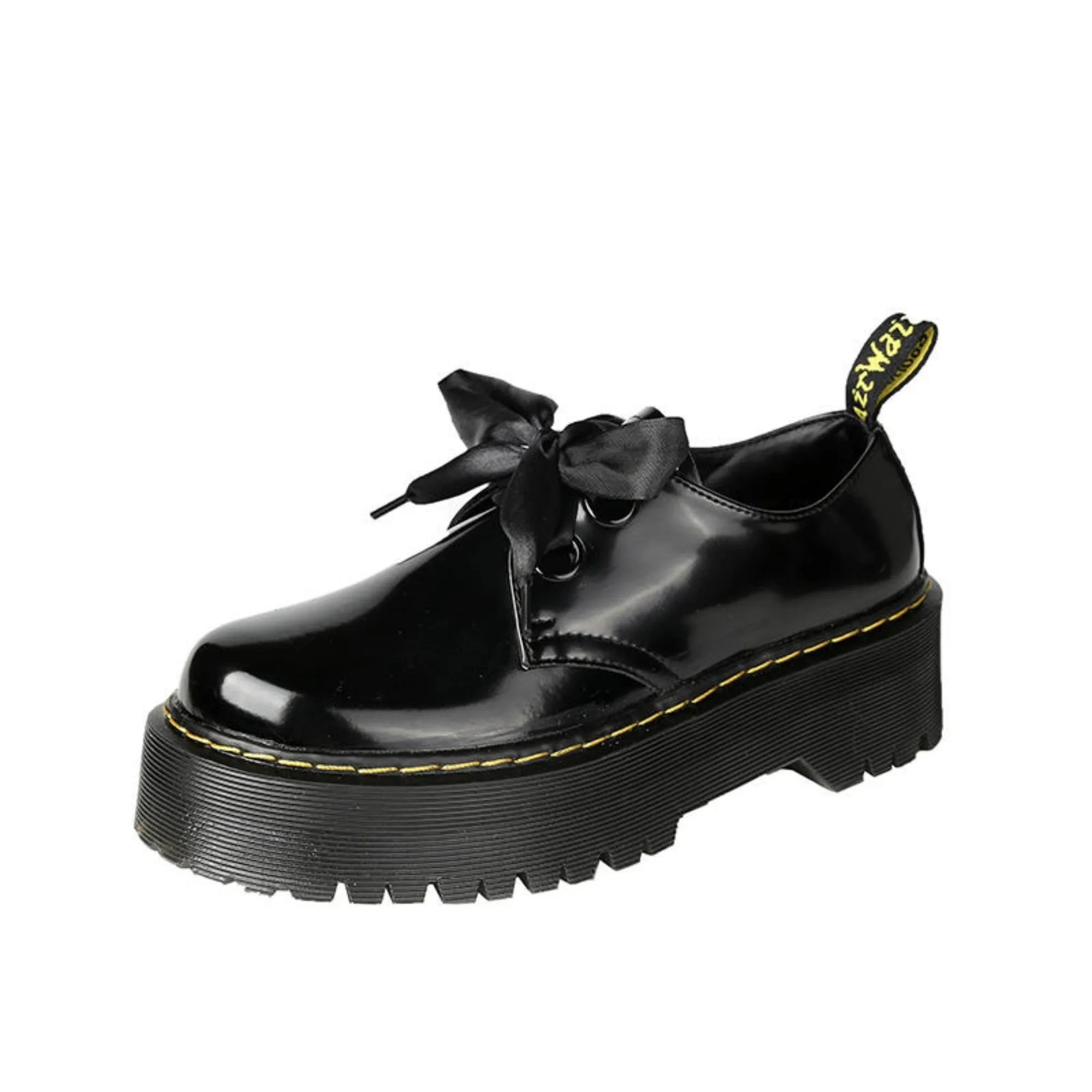 Women's white and black thick soled leather shoes with cross strap and ribbon detail on a superfine fibre upper.