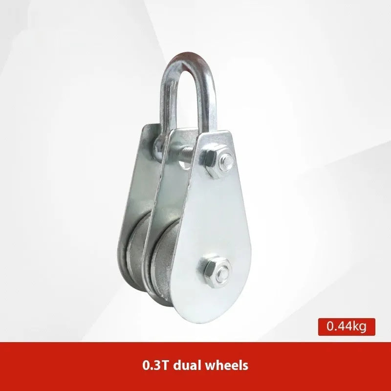 Red industrial steel lifting pulley with a safety latch on the hook.
