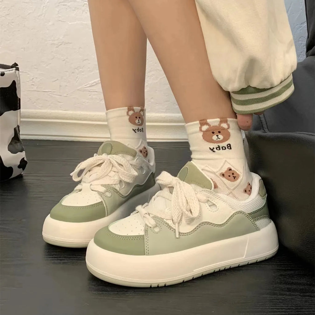 Green women's casual shoes with mesh upper, flat heels, and round toe design