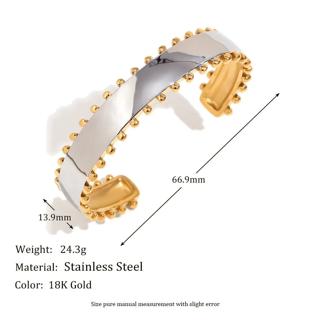Gold geometric stainless steel earrings, bracelet, and necklace set on a white background.