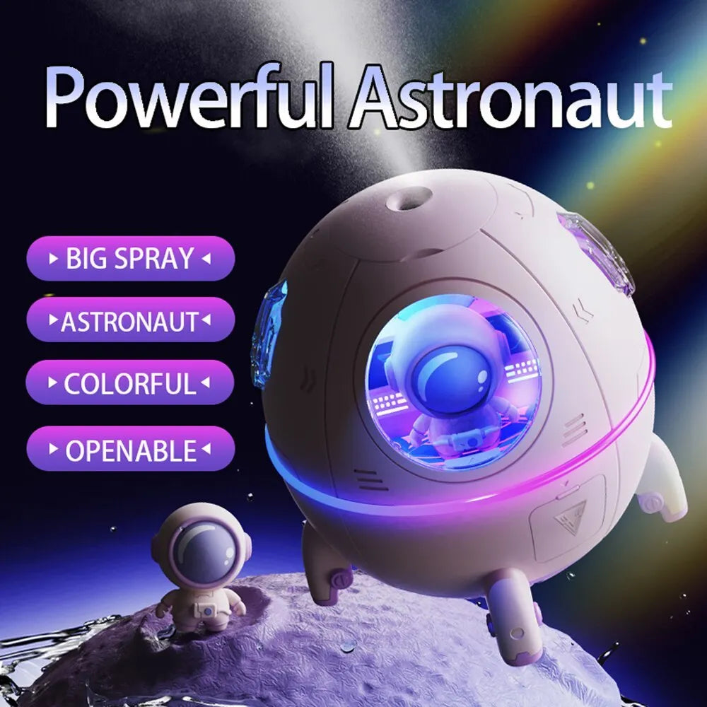 Purple astronaut-themed desktop USB humidifier with LED light next to USB cable on a desk.