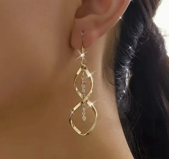 Gold colour geometric spiral design alloy earrings with elliptical elements for female wearers