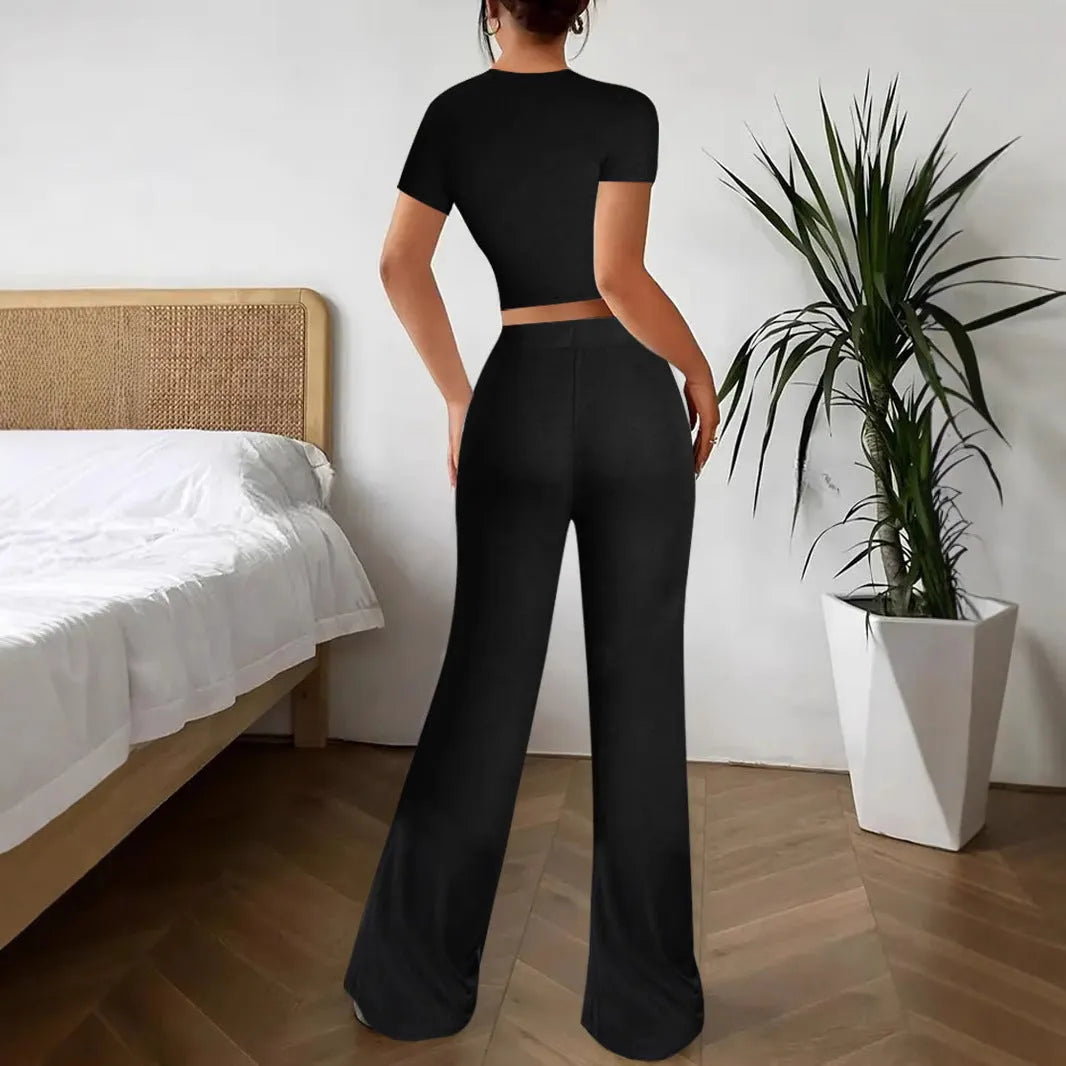 Black women's co-ord suit with high-waist trousers and a short-sleeve T-shirt on a hanger.