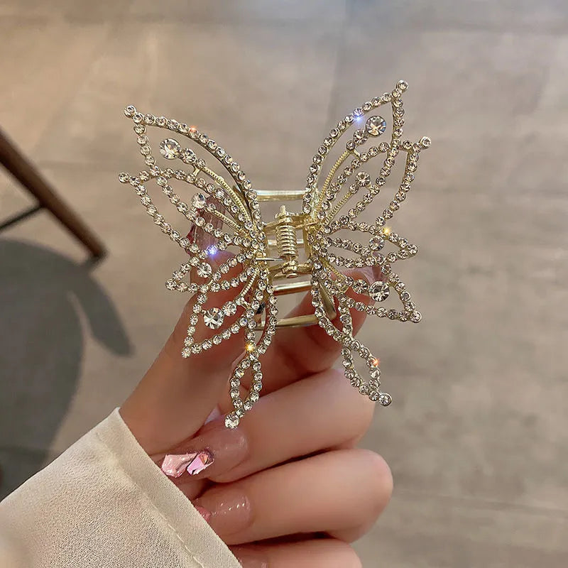 Butterfly-shaped hair clip with metal alloy construction and decorative rhinestone or pearl elements