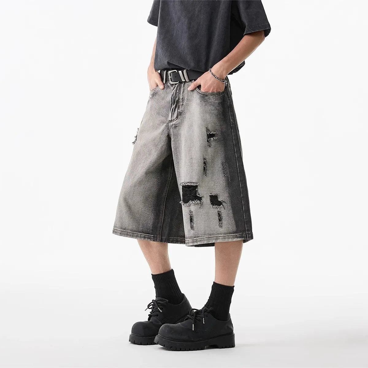 Grey water washed hole denim shorts with loose fit and cropped length on hanger