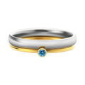 Geometric titanium steel ring with engraved December birthstone design on a finger.