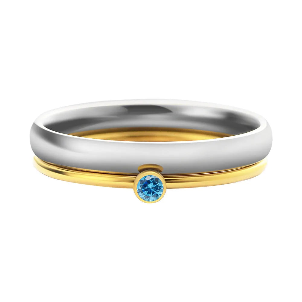 Geometric titanium steel ring with engraved December birthstone design on a finger.