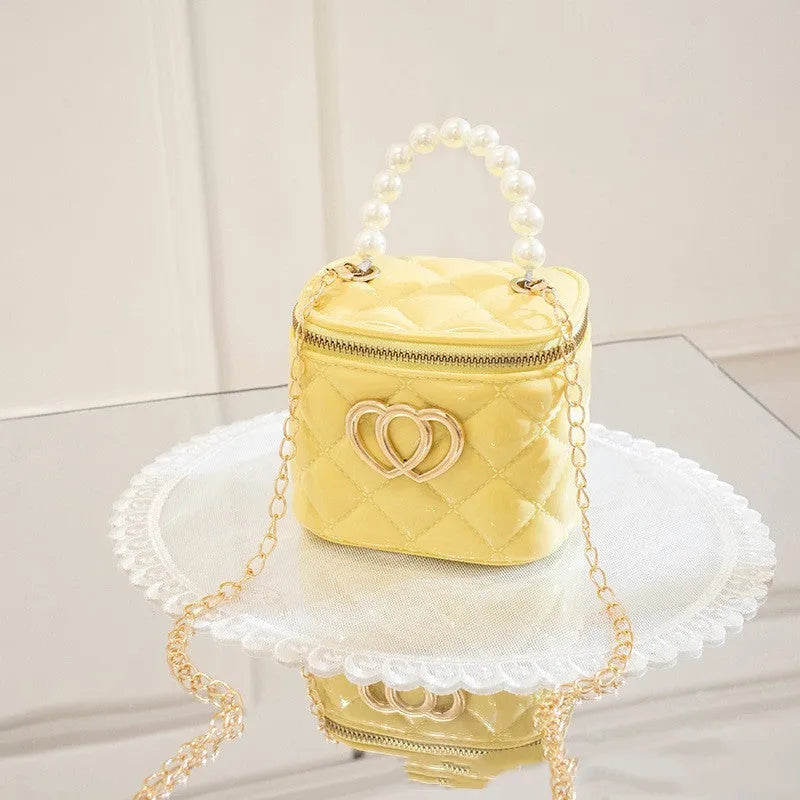 Women's white PVC bucket gel handbag with a red heart-shaped pattern lining.