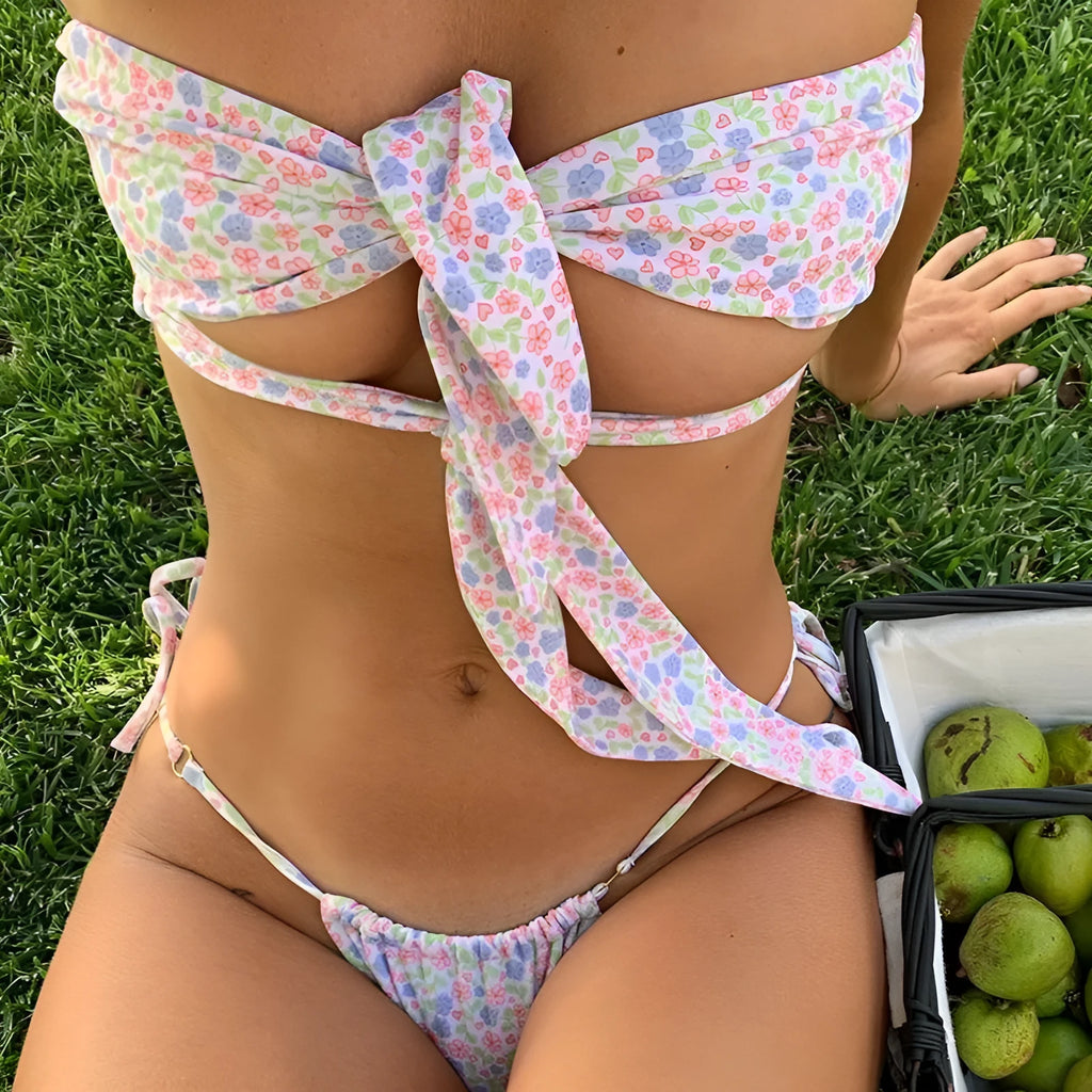 Women's lace-up front swimsuit with high-leg split and built-in chest pad, shown in a floral print.
