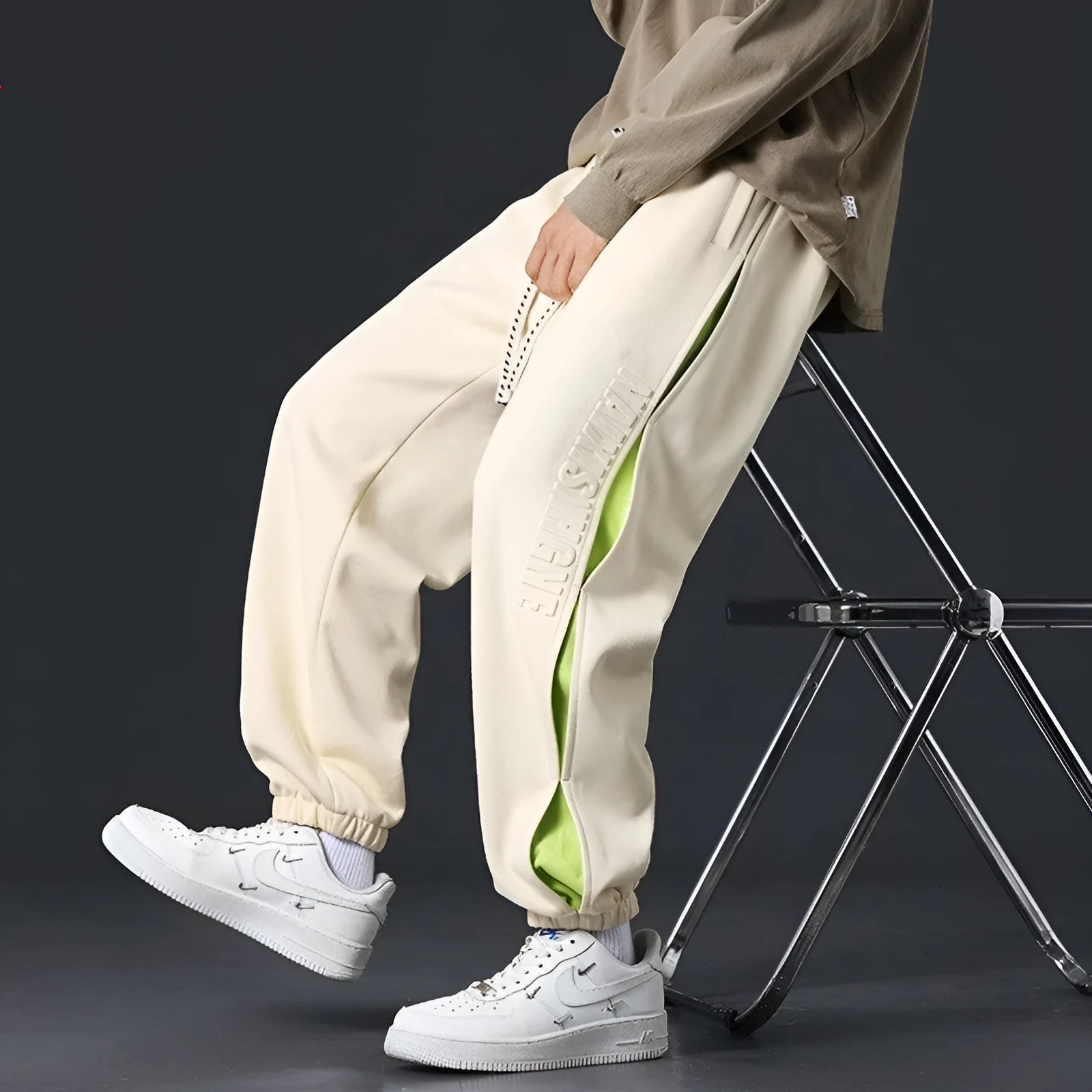 Men's loose fit cotton casual trousers with stitching print design and banded ankle cuffs.