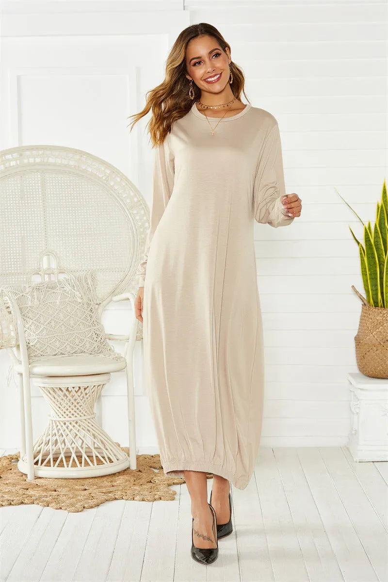 Black knitted lantern dress with loose fit sleeves and lace-up front detail on a mannequin.