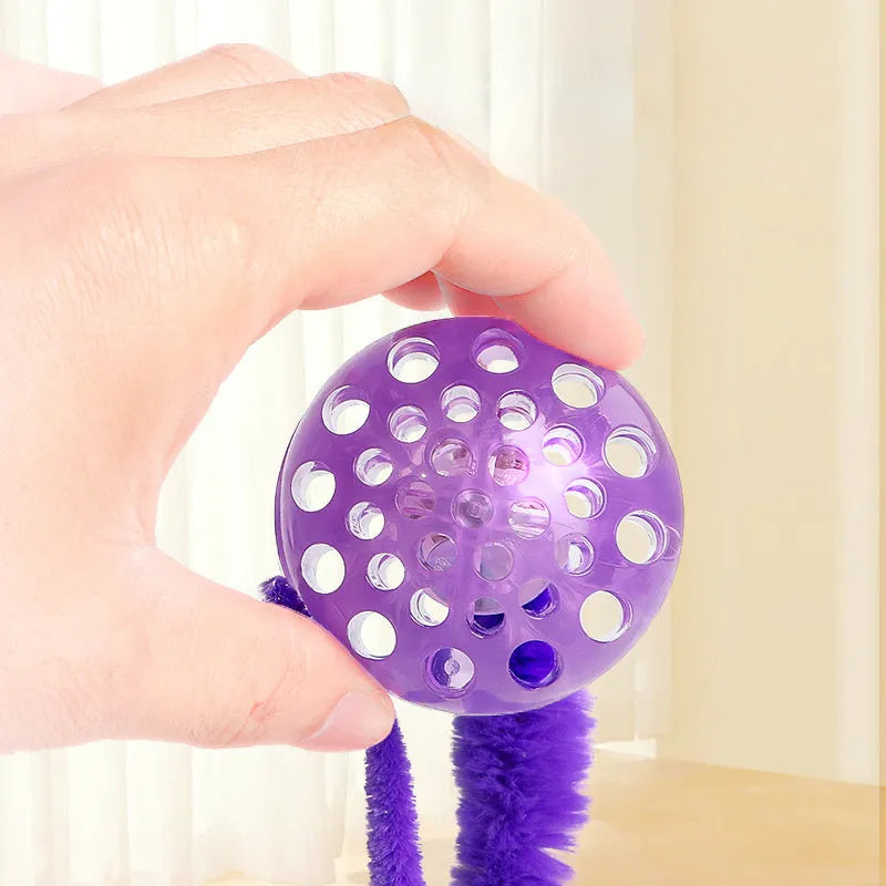 Interactive cat ball toy with worm tail attachment in green, pink, or purple colours