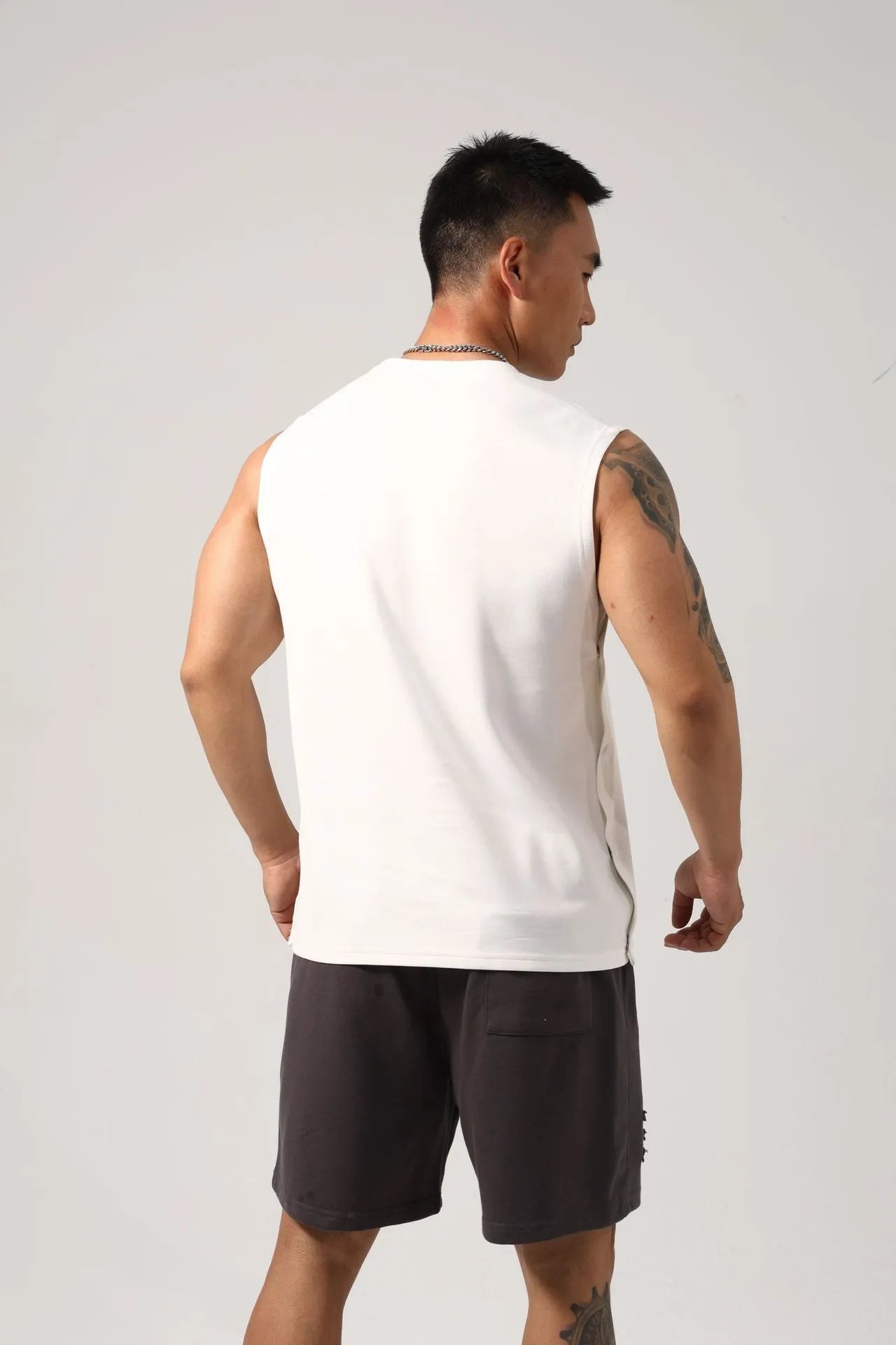 Korean style men's loose cotton fitness vest with hidden side hooks in black.