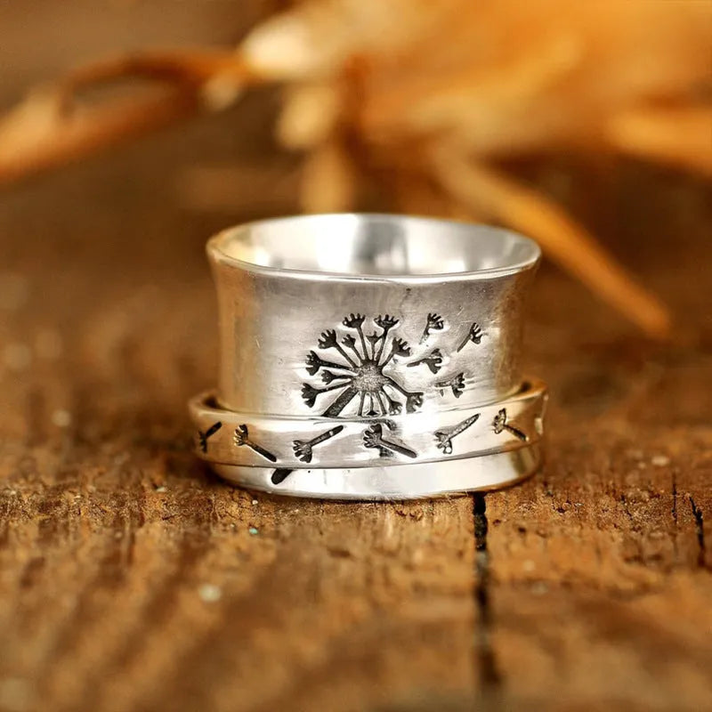 Silver rotatable flower ring showing adjustable floral element on finger