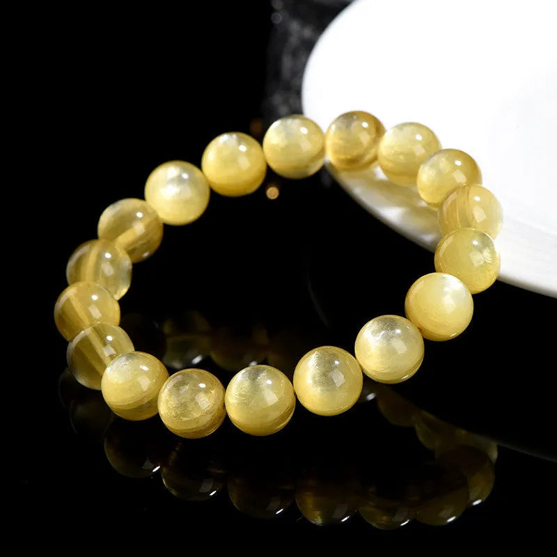 Yellow dragon gold lepidolite mica bead bracelet with geometric round beads on wrist