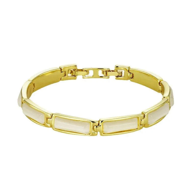 Women's geometric rose gold opal bracelet with quadrilateral shape and gemstone inlay on a plain background
