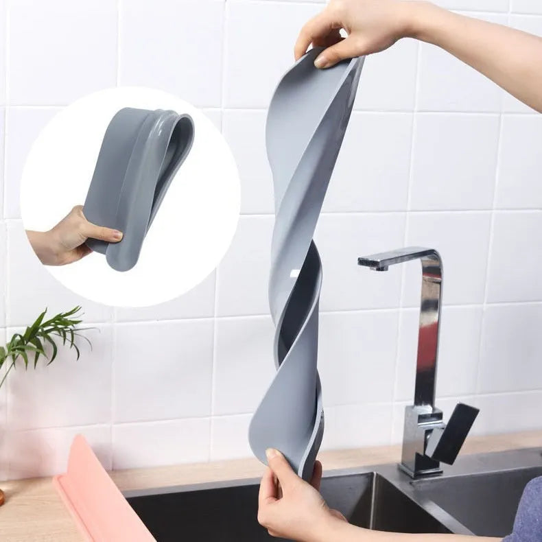 A thick grey silicone kitchen sink water blocking plate or splash guard measuring 52mm by 85mm.