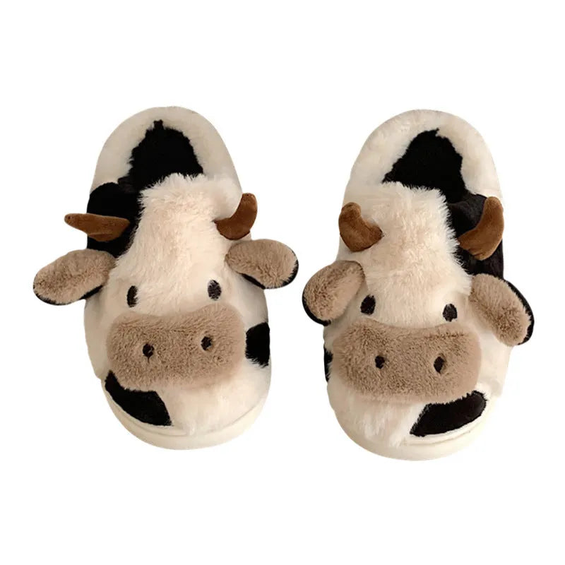 White cartoon cow design faux fur slippers for women with a non-slip textured sole.