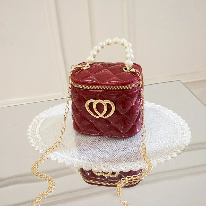 Women's white PVC bucket gel handbag with a red heart-shaped pattern lining.