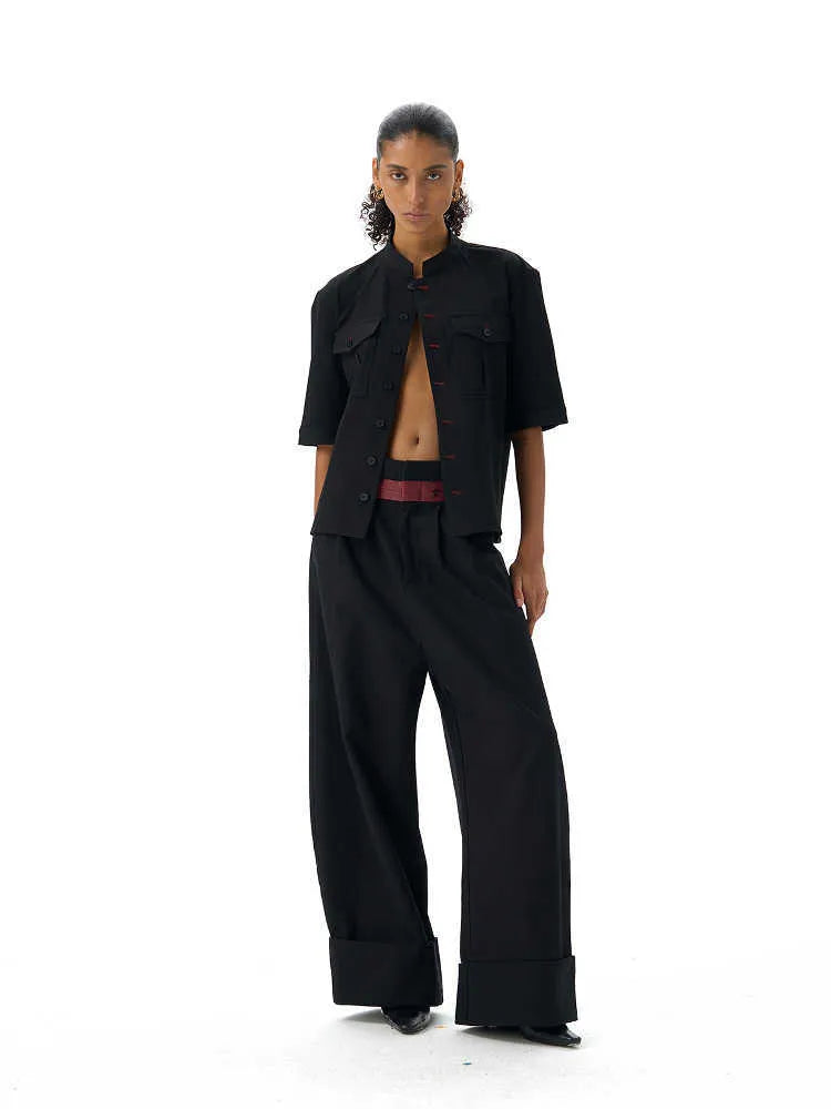Black handmade loose fit half sleeve hunting shirt with a traditional shirt collar on a hanger.