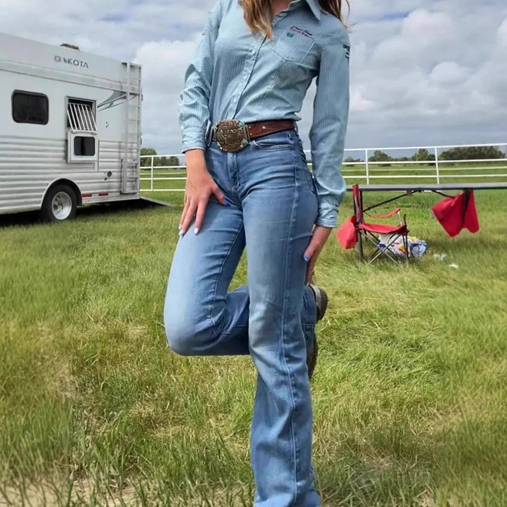 Blue embroidered women's slim-fit jeans with a slight flare and mid-rise waist.