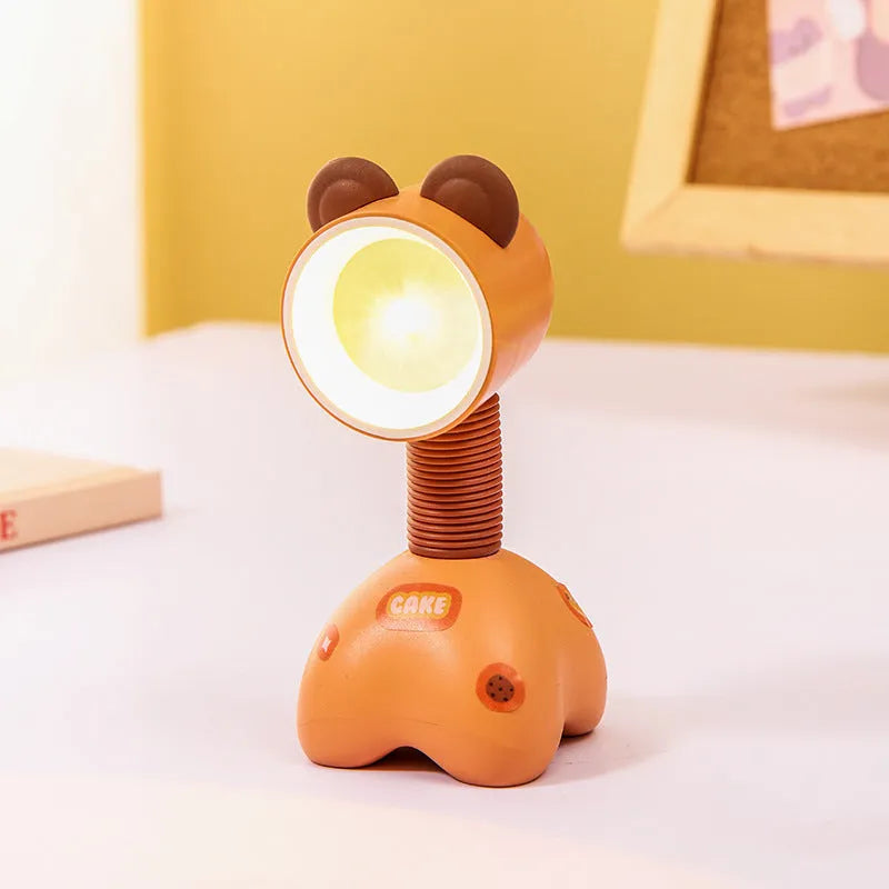 DIY cartoon animal small night lamp with magnetic base in assorted colours on a desk.