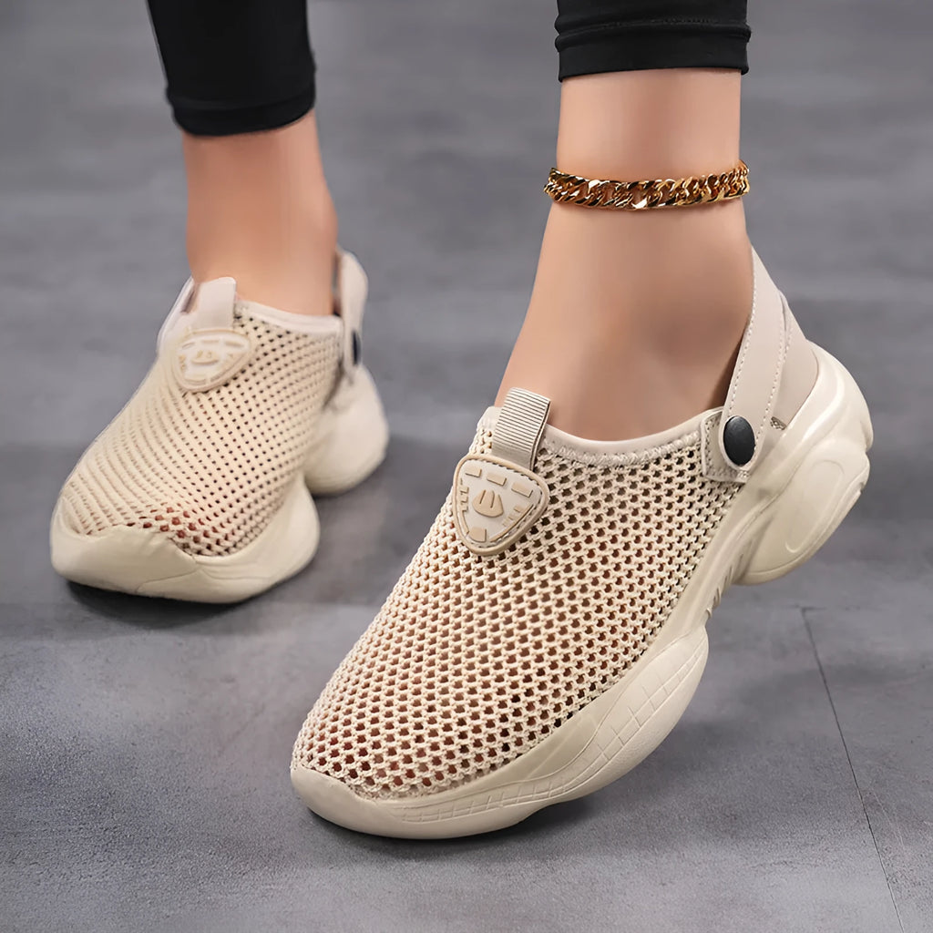 Women's beige Flyknit casual sports sandals with round toe holder, shown on a foot.