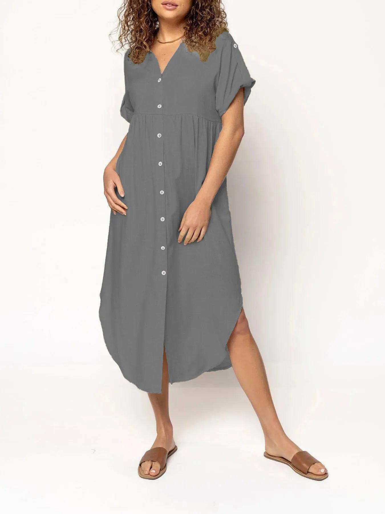 Loose-fitting casual solid colour button dress in a mid-length style on a hanger.
