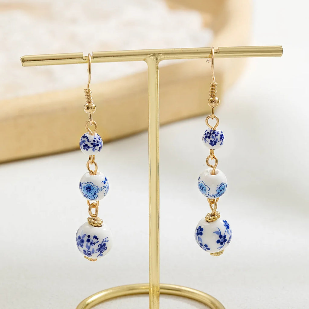 Blue and white porcelain ceramic bead long drop earrings with geometric alloy design